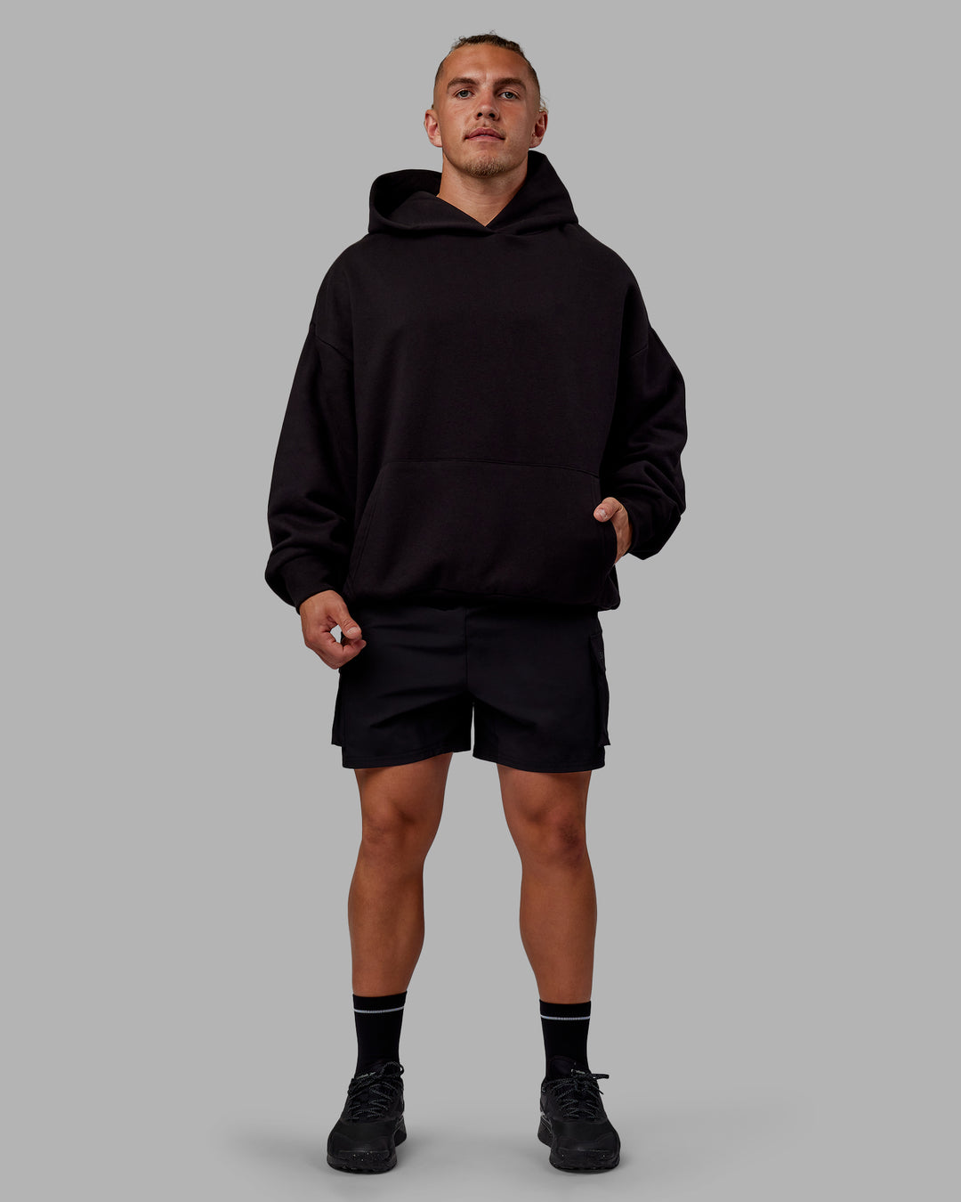 Man wearing Sara Unisex Hoodie Oversize - Black-Black