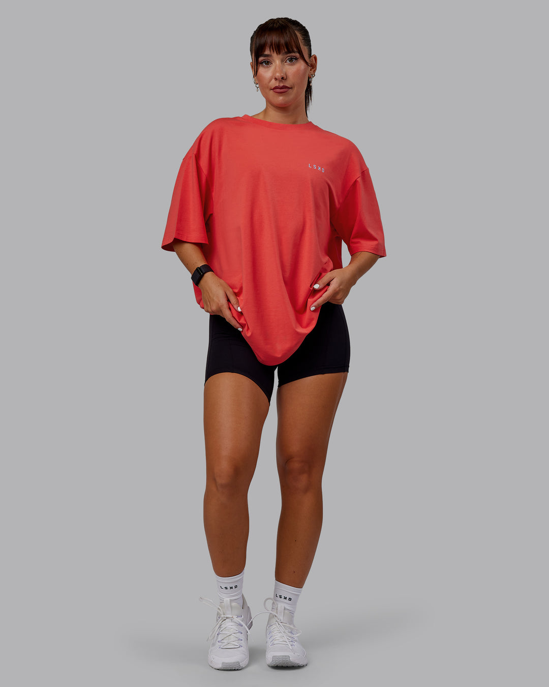 Woman wearing Unisex Strike Through FLXCotton Tee Oversize - Cayenne-Glacial Blue