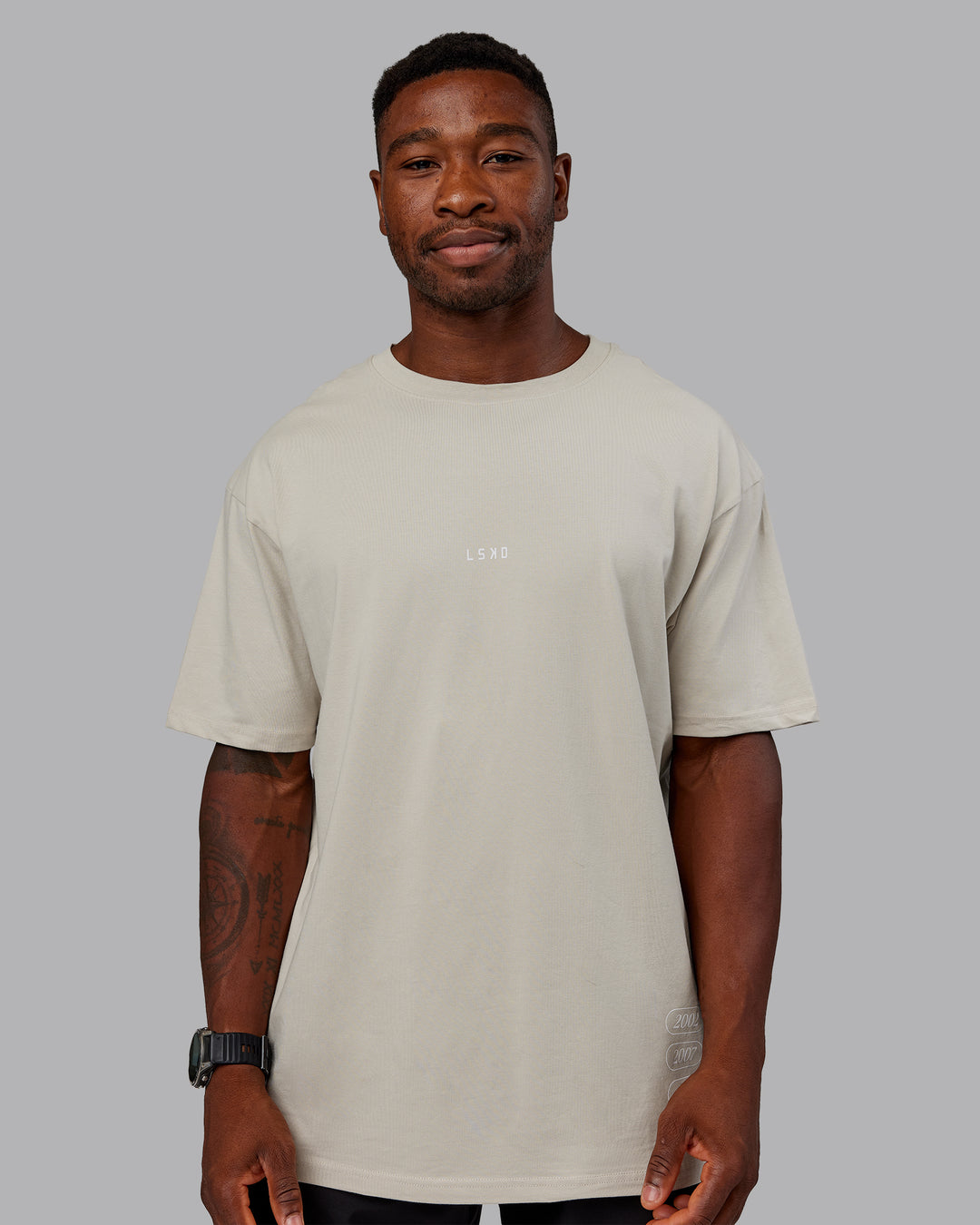 Man wearing Timeline FLXCotton Oversized Tee - Shale Beige-White | Model:Sam | Size:L