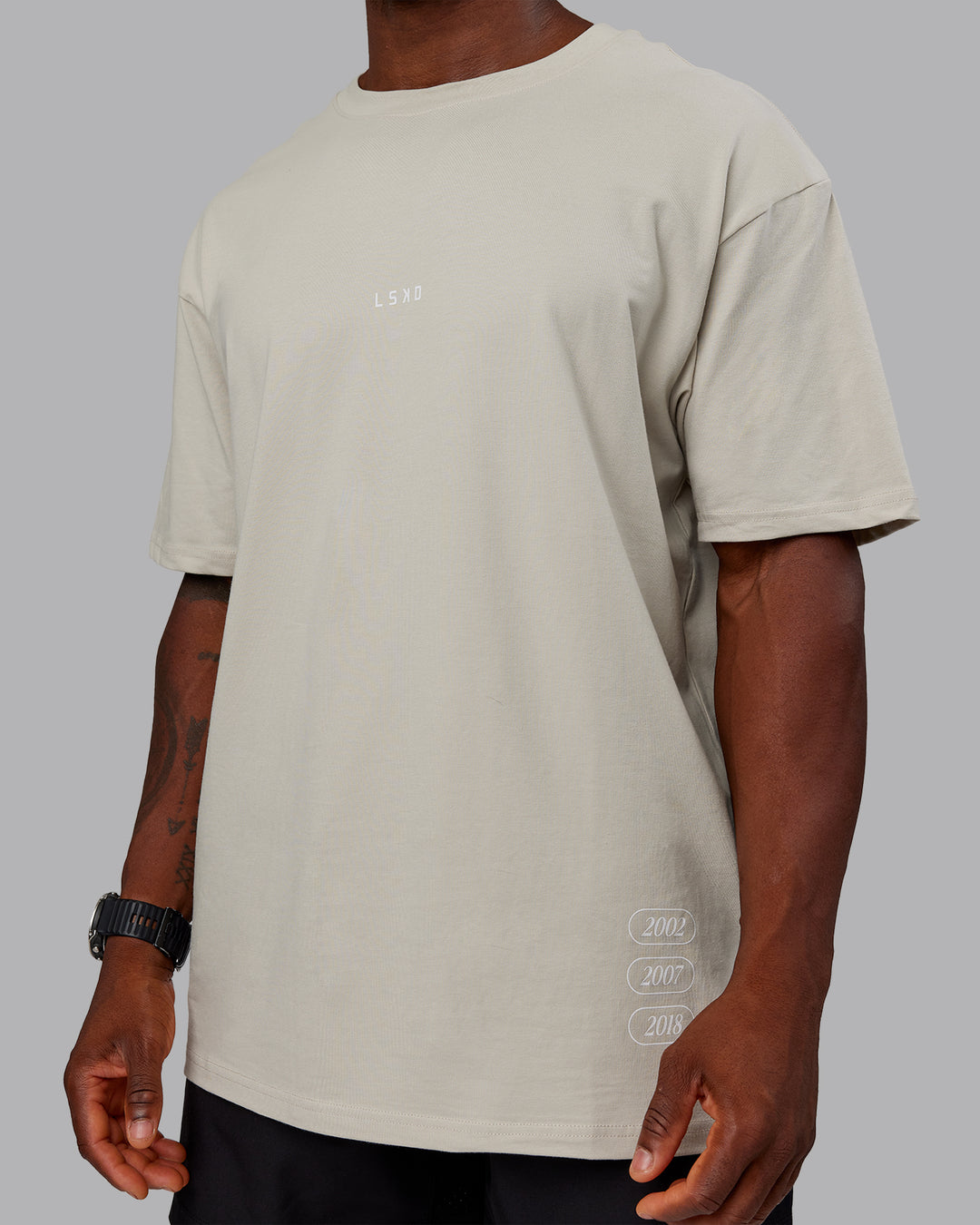 Man wearing Timeline FLXCotton Oversized Tee - Shale Beige-White | Model:Sam | Size:L