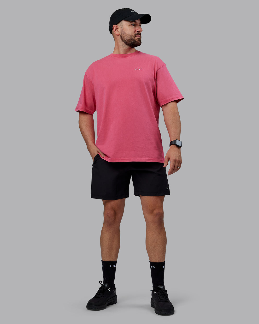 Man wearing Unisex Washed Empower Tee Oversize - Berry Pink-Pastel Orchid