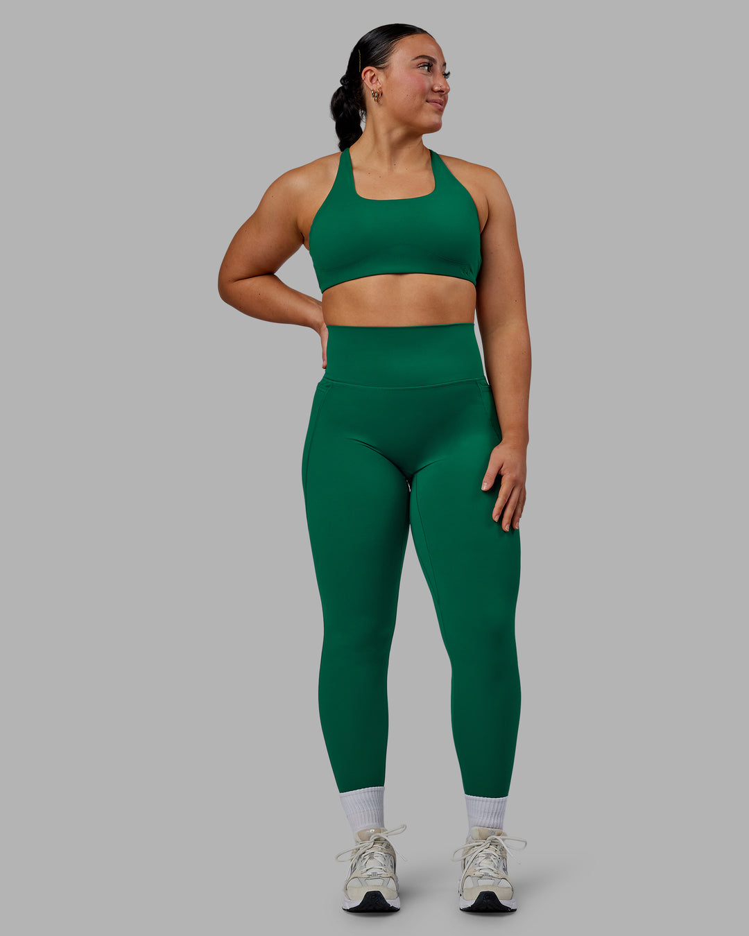 Woman wearing Aspire Sports Bra - Malachite