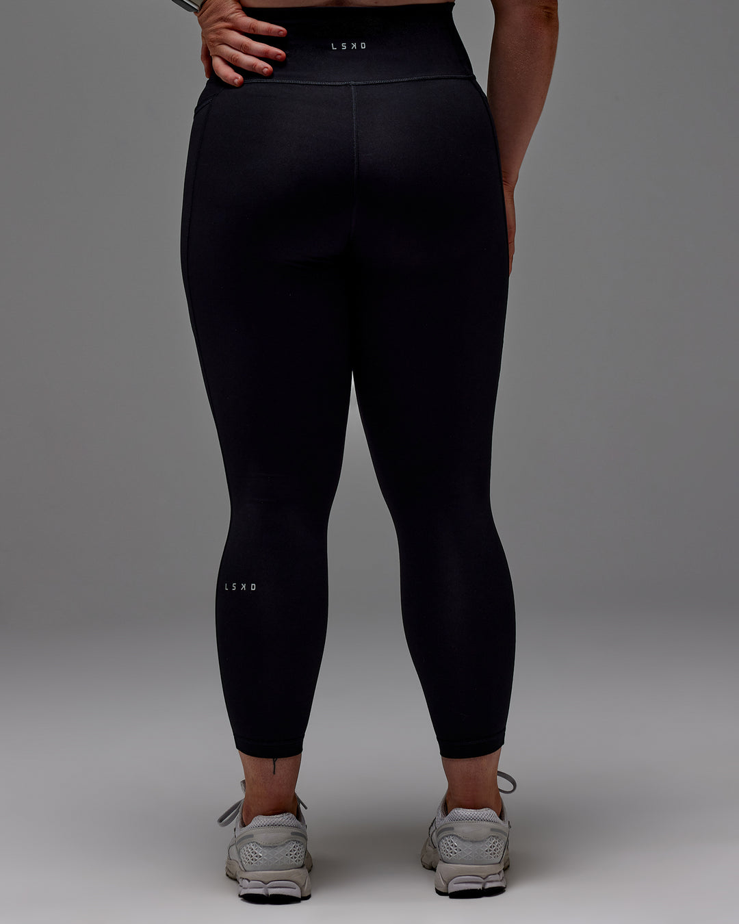 Woman wearing Fusion 7/8 Length Tight With Pockets in Black | Model:Caity | Size:M