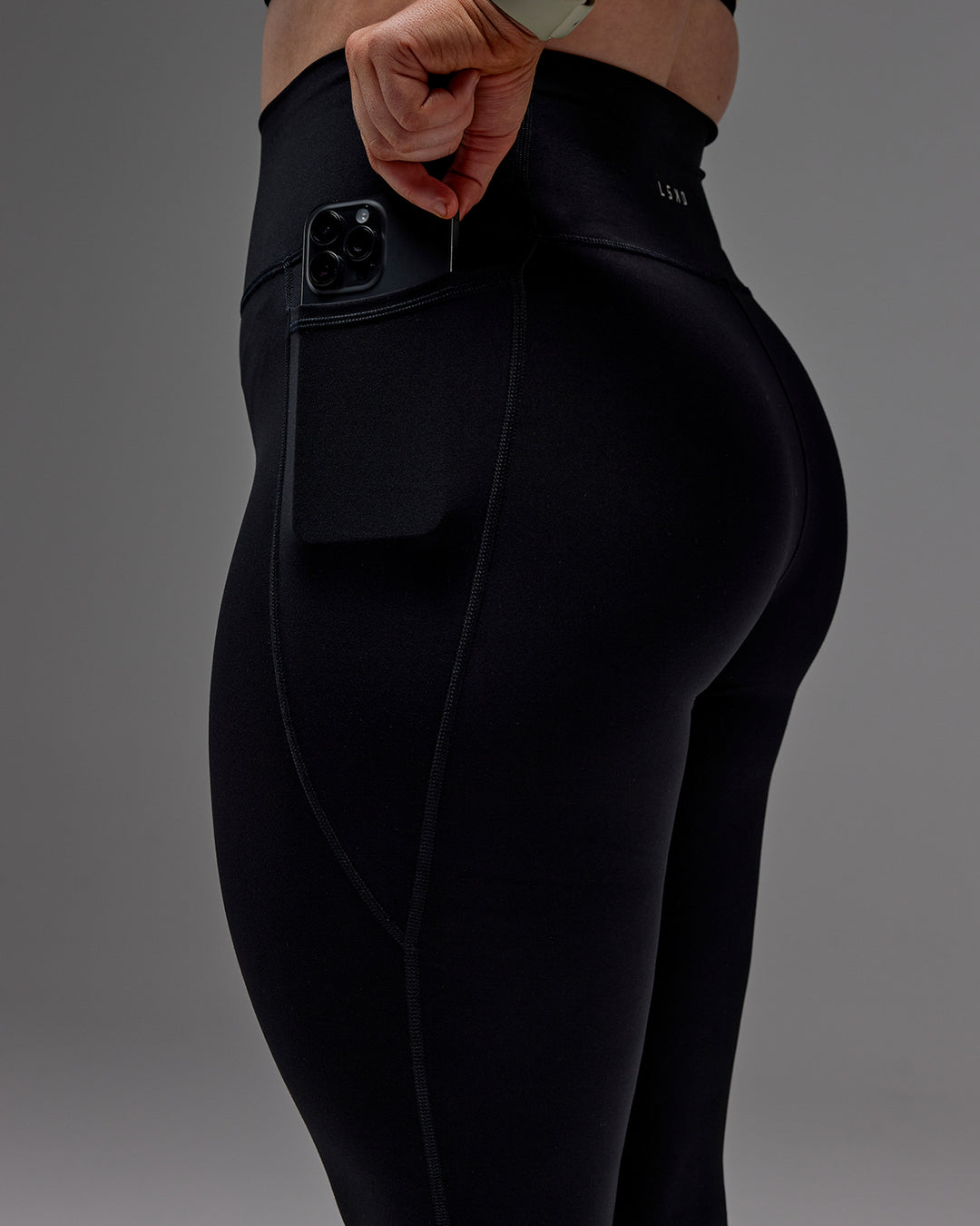 Woman wearing Fusion 7/8 Length Tight With Pockets in Black | Model:Caity | Size:M