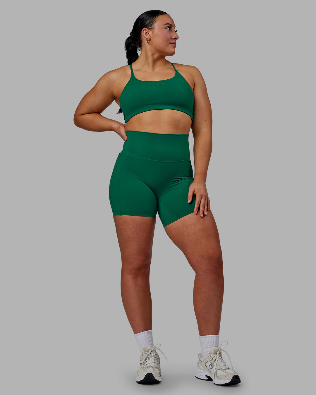 Woman wearing Twist Sports Bra - Malachite