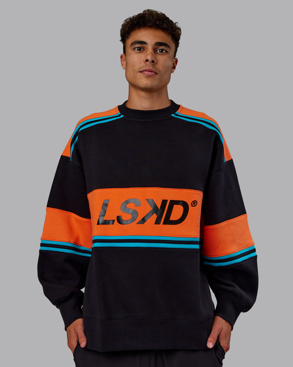 Man wearing A-Team Sweater Oversize - Black-Ultra Orange | Model:Jaxon | Size:M