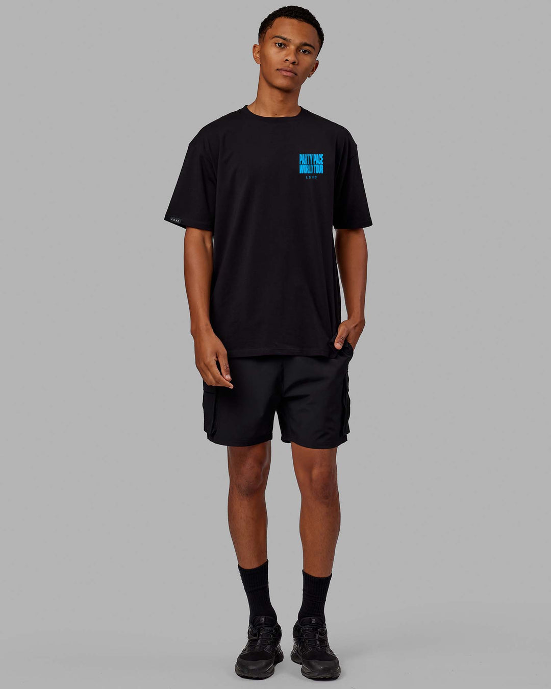 Man wearing Unisex Party Pace FLXCotton Oversize Tee - Black-Blue  Edit alt text