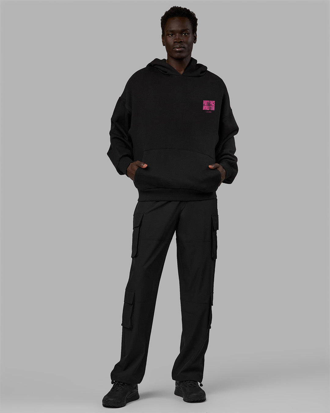 Man wearing Unisex Party Pace Hoodie Oversize - Black-Pink