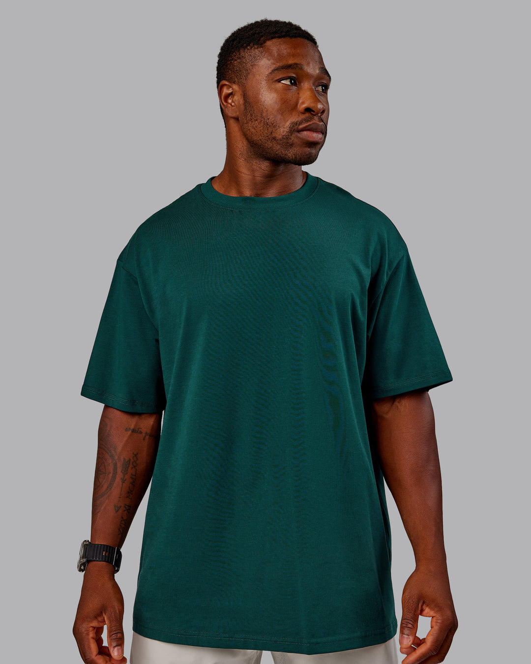 Man wearing Variation FLXCotton Oversized Tee in Dark Moss-Digital Mist | Size:M