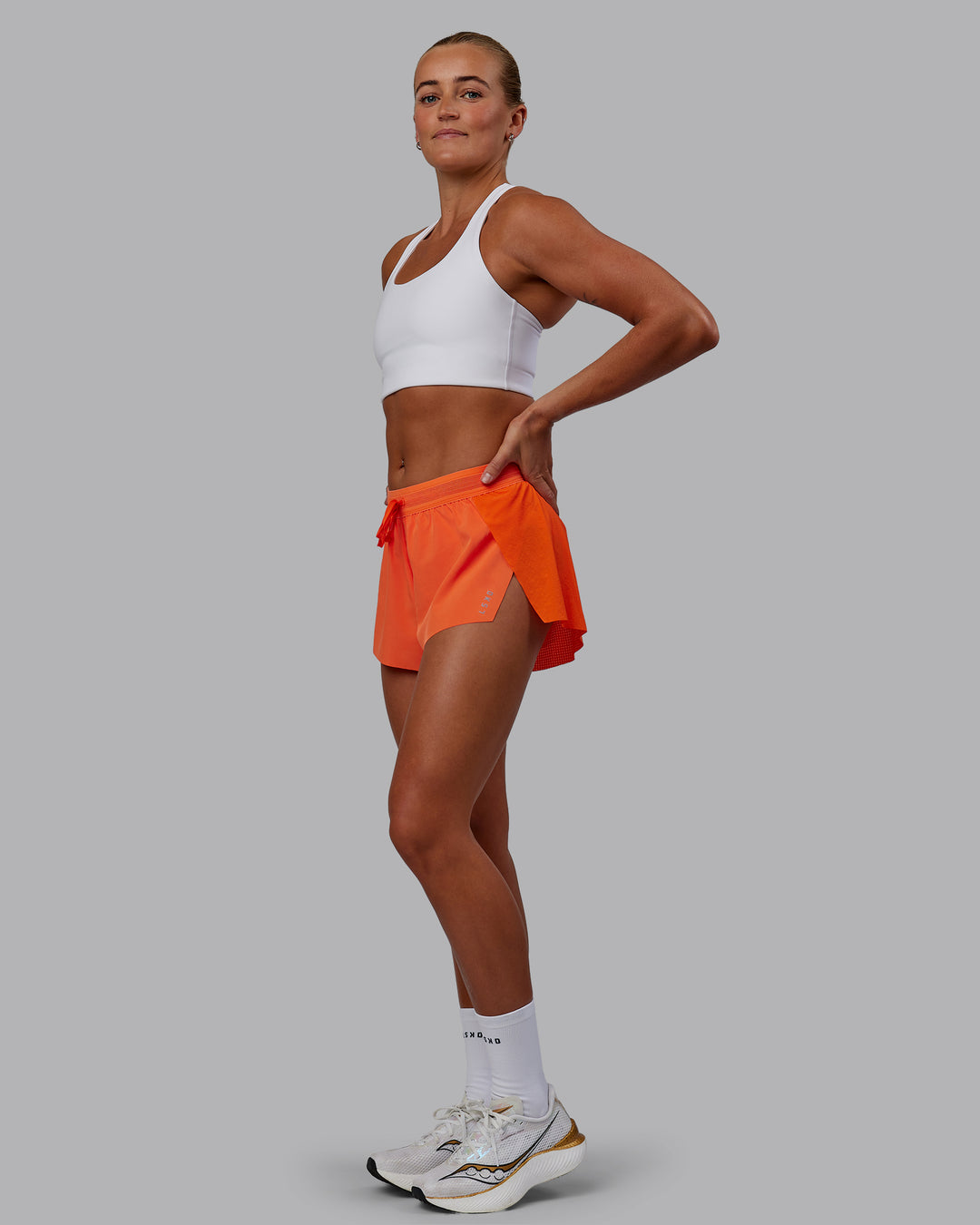 Woman wearing Accelerate Run Shorts - Ultra Orange