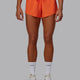 Woman wearing Accelerate Run Shorts - Ultra Orange