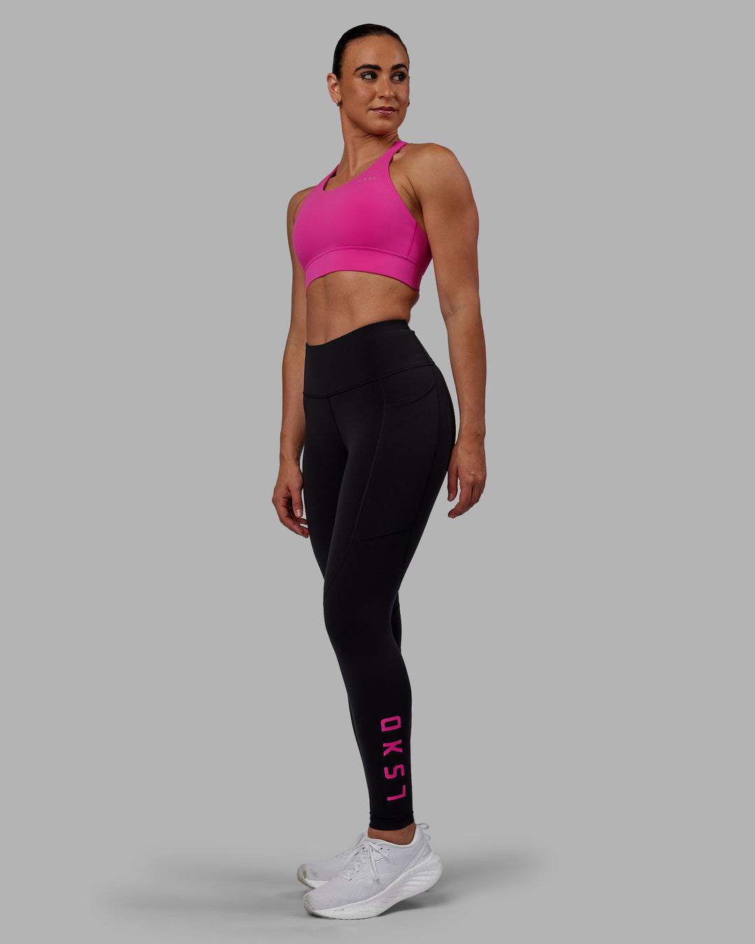 Woman wearing Accelerate Sports Bra - Fuchsia Pink