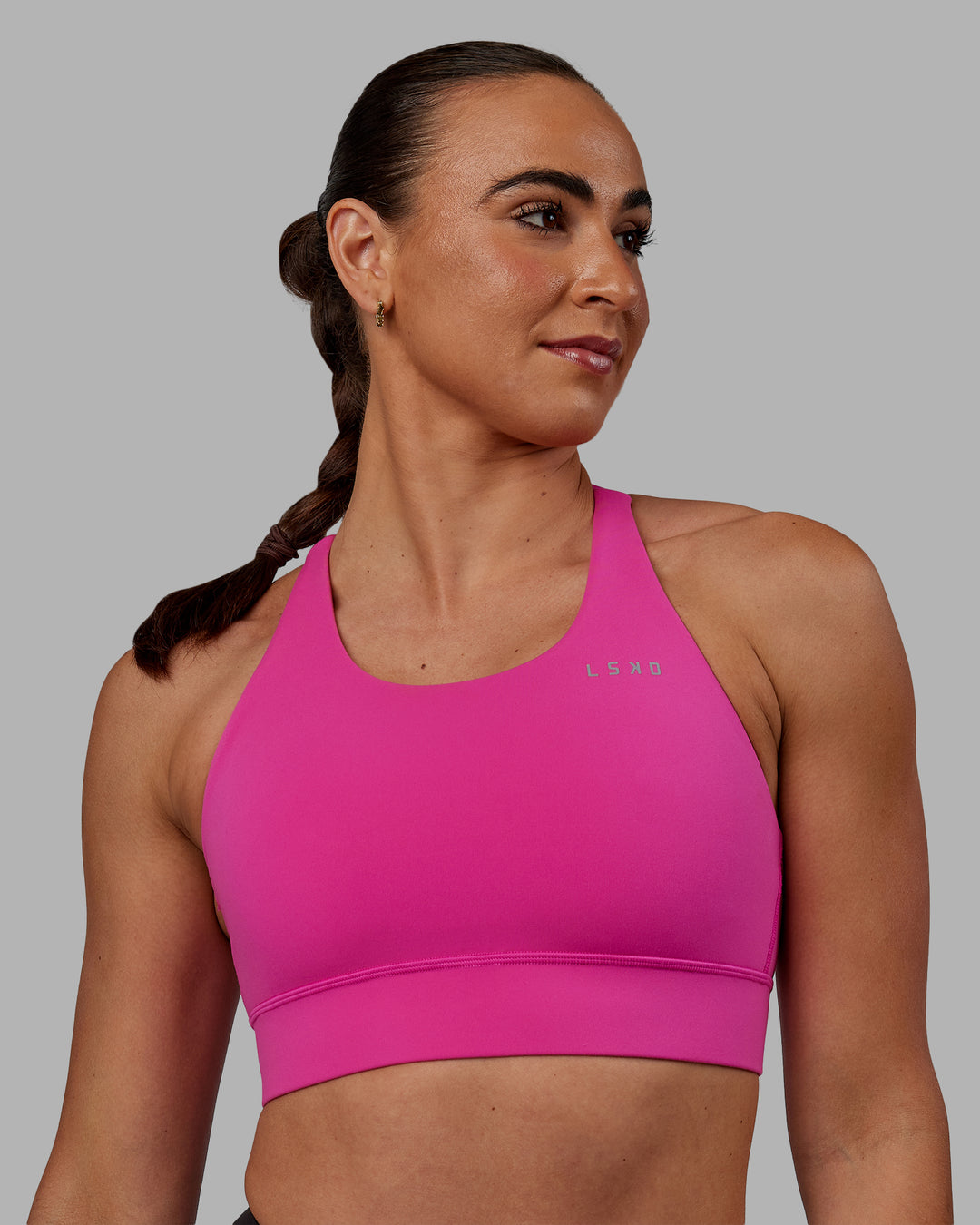 Woman wearing Accelerate Sports Bra - Fuchsia Pink