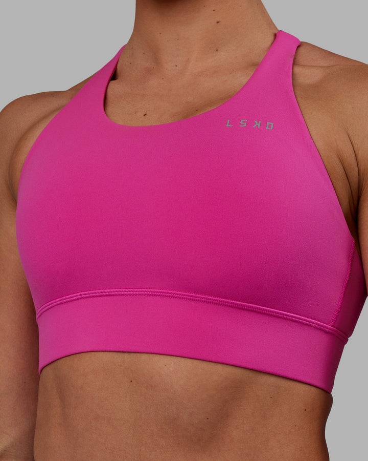 Woman wearing Accelerate Sports Bra - Fuchsia Pink
