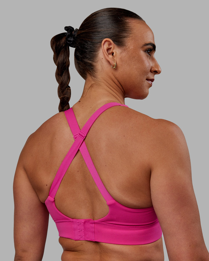 Woman wearing Accelerate Sports Bra - Fuchsia Pink
