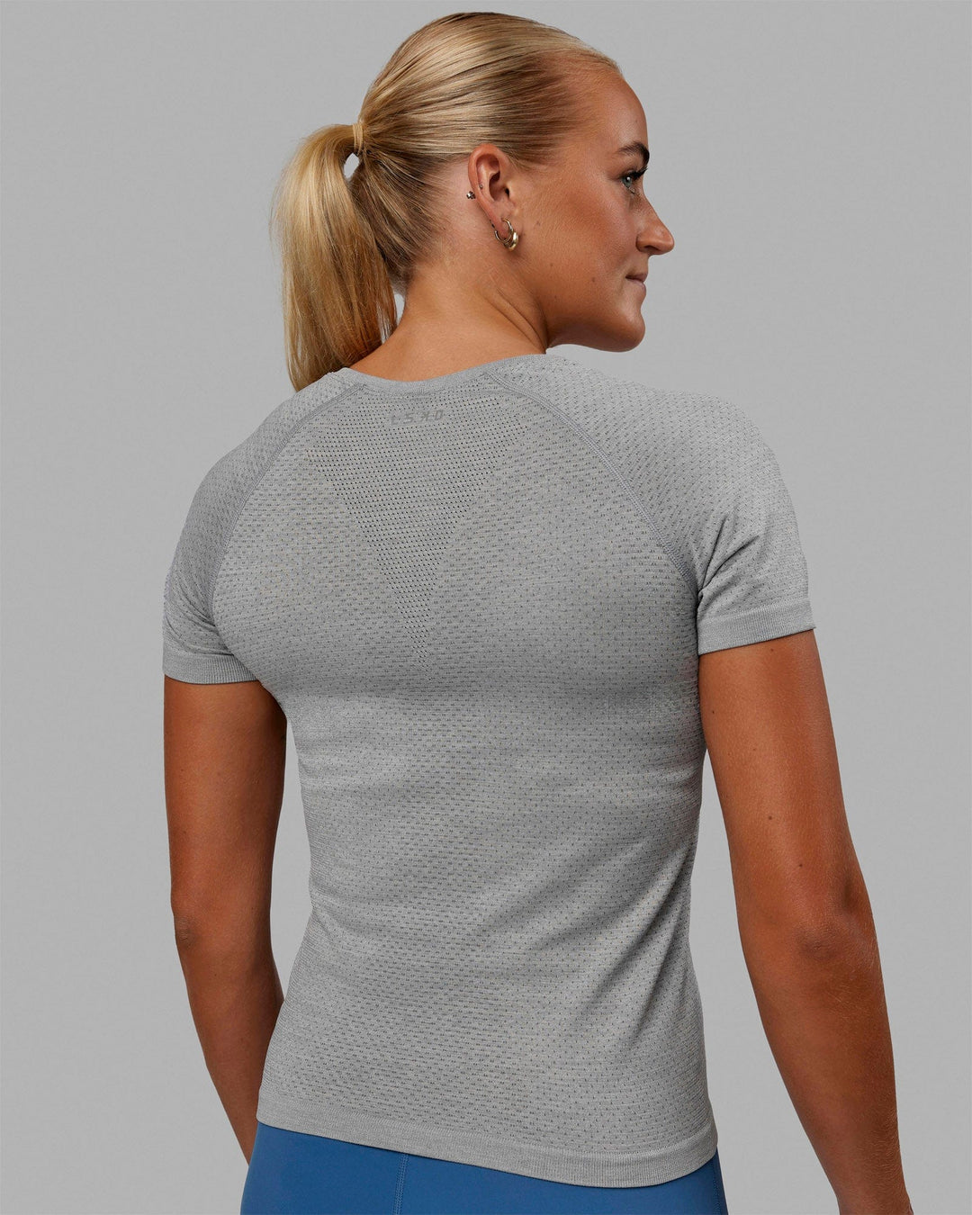 Woman wearing AeroFLX+ Seamless Tee - Light Grey Marl