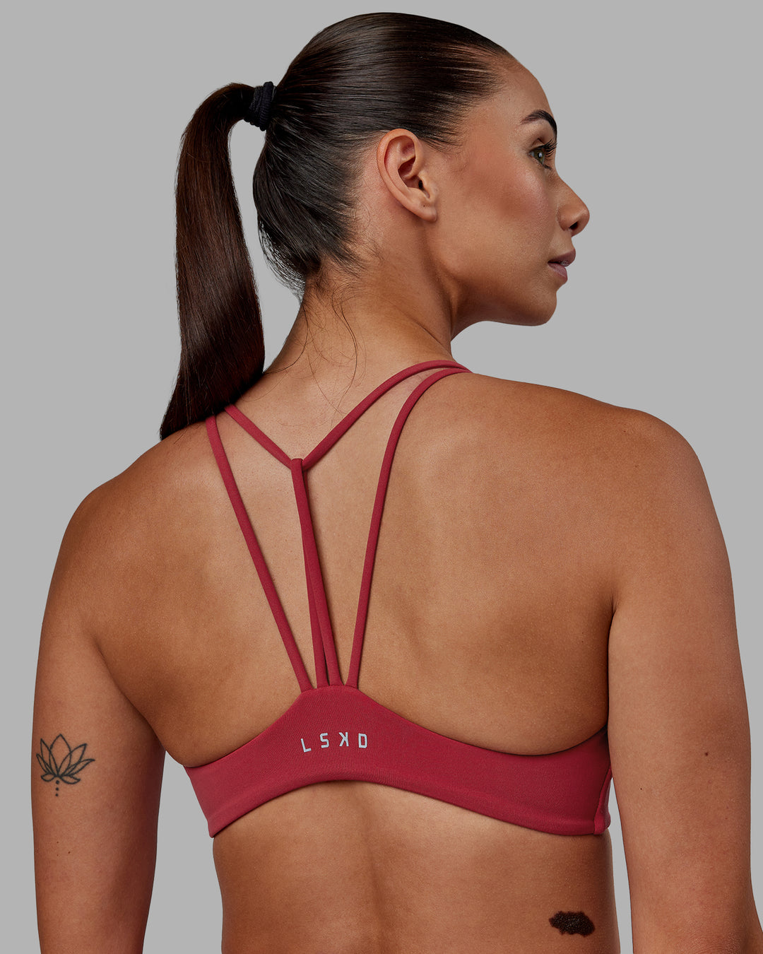 Woman wearing Agile Sports Bra - Claret