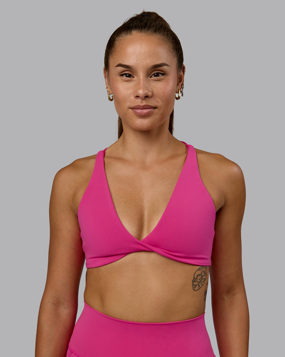 Woman wearing Agile Sports Bra - Fuchsia Pink