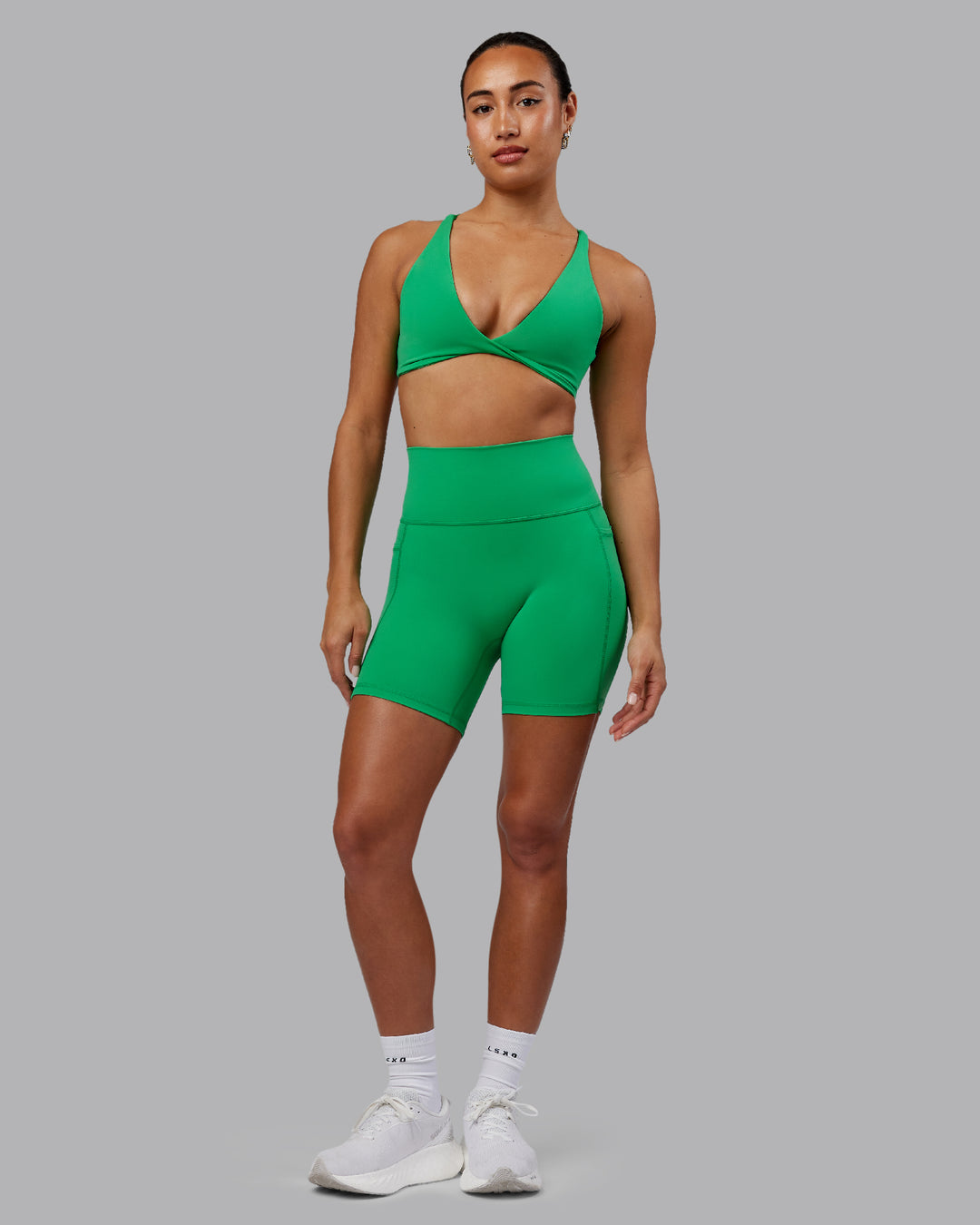 Woman wearing Agile Sports Bra - Impact Green