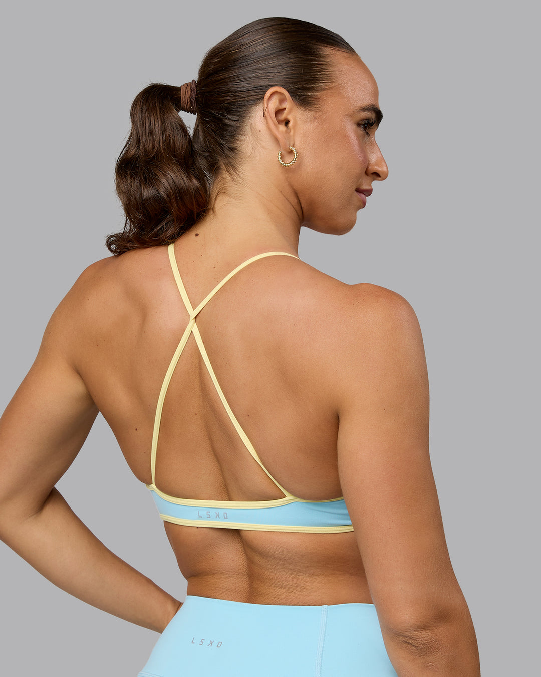 Woman wearing Ambience Sports Bra - Crystal Blue-Lemon