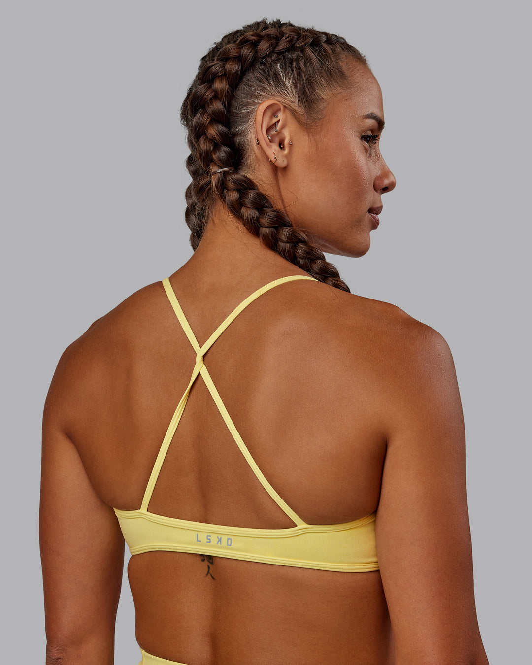 Woman wearing Ambience Sports Bra - Lemon Fizz