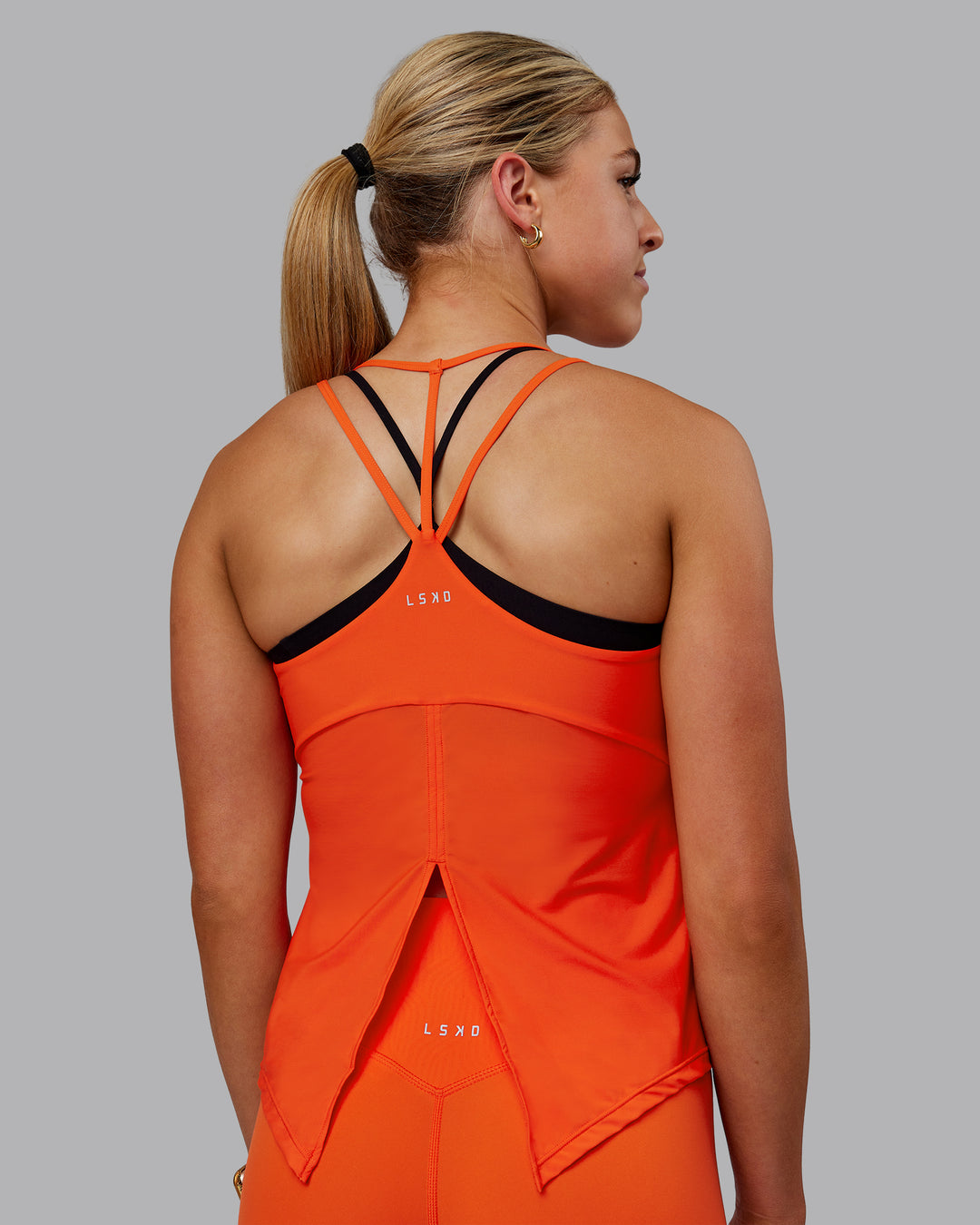 Woman wearing Apex Lightweight Performance Tank - Grenadine