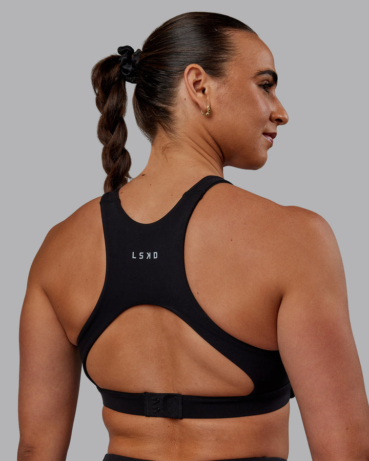 Woman wearing Ascent Sports Bra - Black
