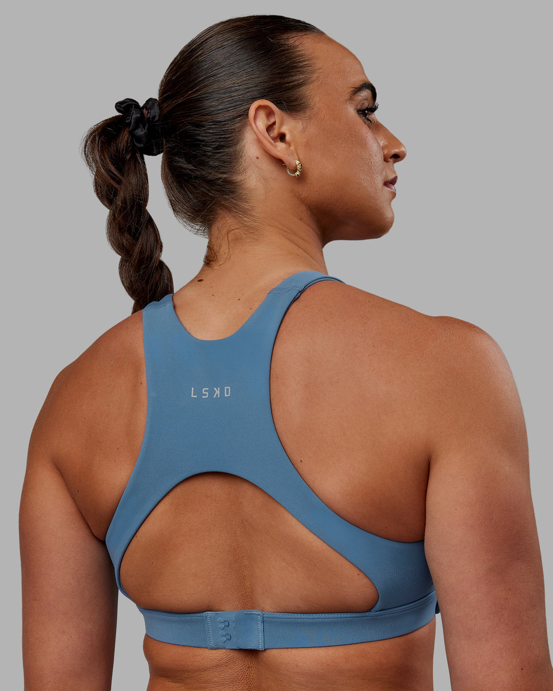 Woman wearing Ascent Sports Bra - Elemental Blue