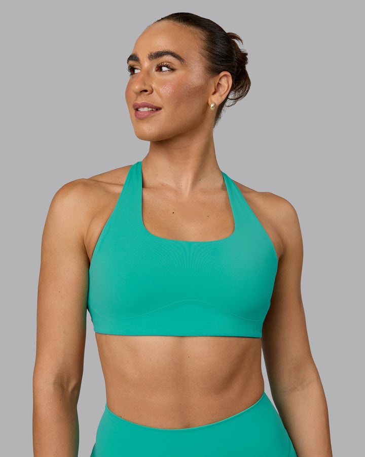 Woman wearing Aspire Sports Bra - Atlantis
