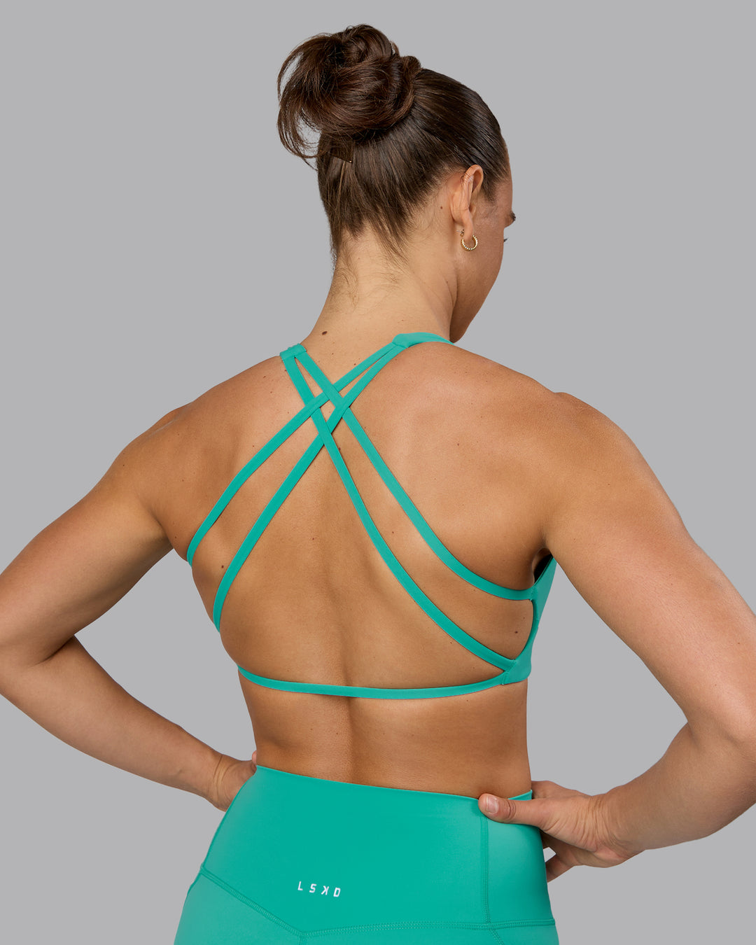 Woman wearing Aspire Sports Bra - Atlantis