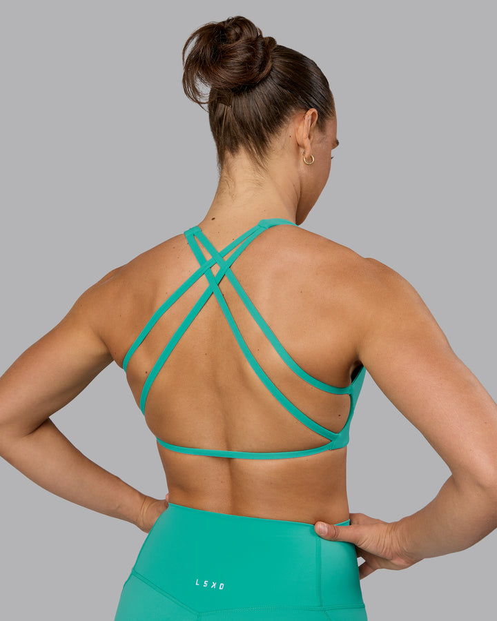 Woman wearing Aspire Sports Bra - Atlantis
