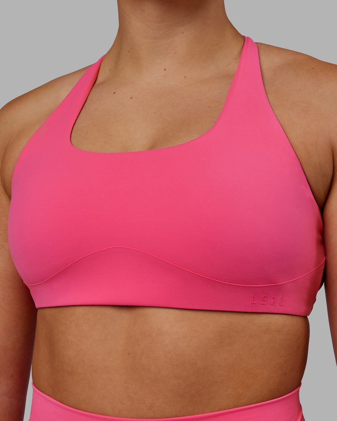 Woman wearing Aspire Sports Bra - Carmine Rose