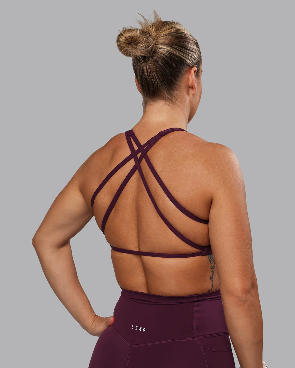 Woman wearing Aspire Sports Bra - Cherry Lacquer