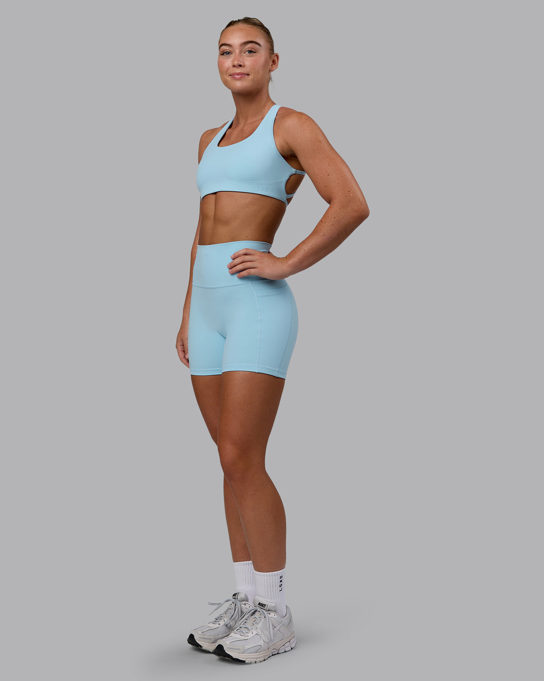 Woman wearing Aspire Sports Bra - Glacial Blue