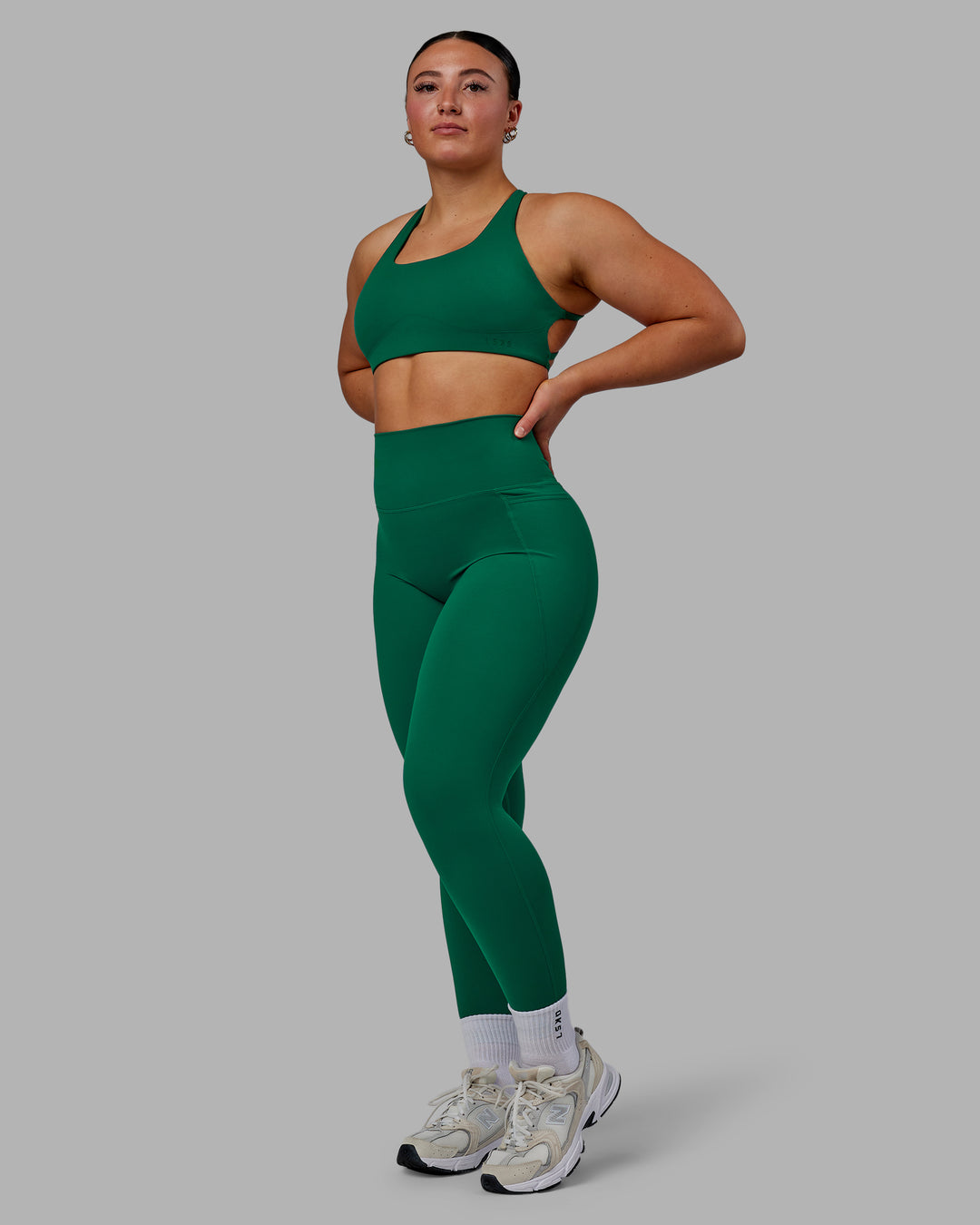 Woman wearing Aspire Sports Bra - Malachite