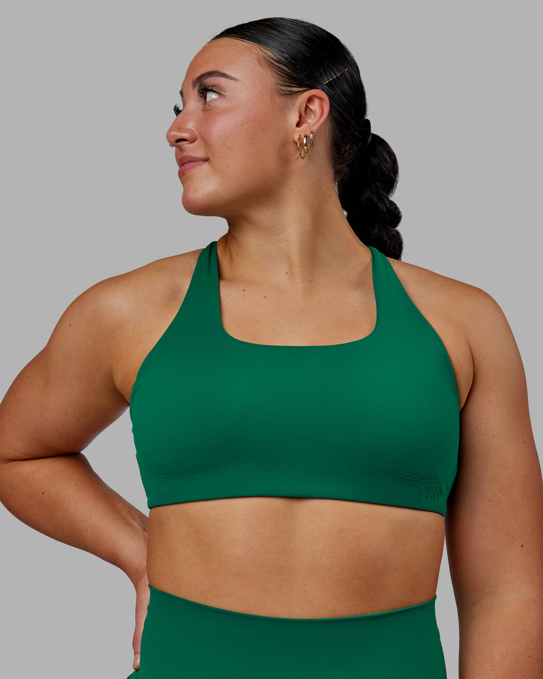 Woman wearing Aspire Sports Bra - Malachite