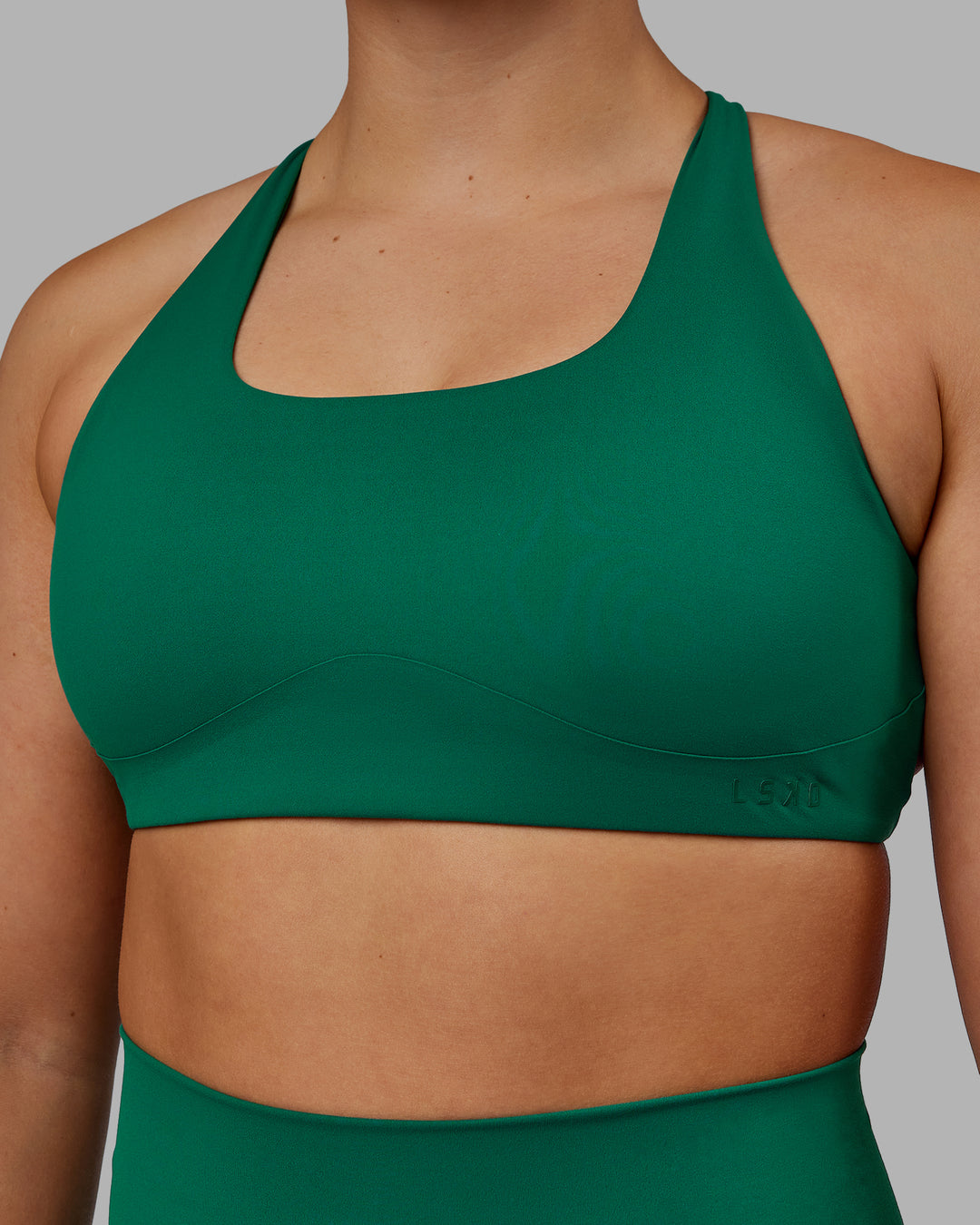 Woman wearing Aspire Sports Bra - Malachite