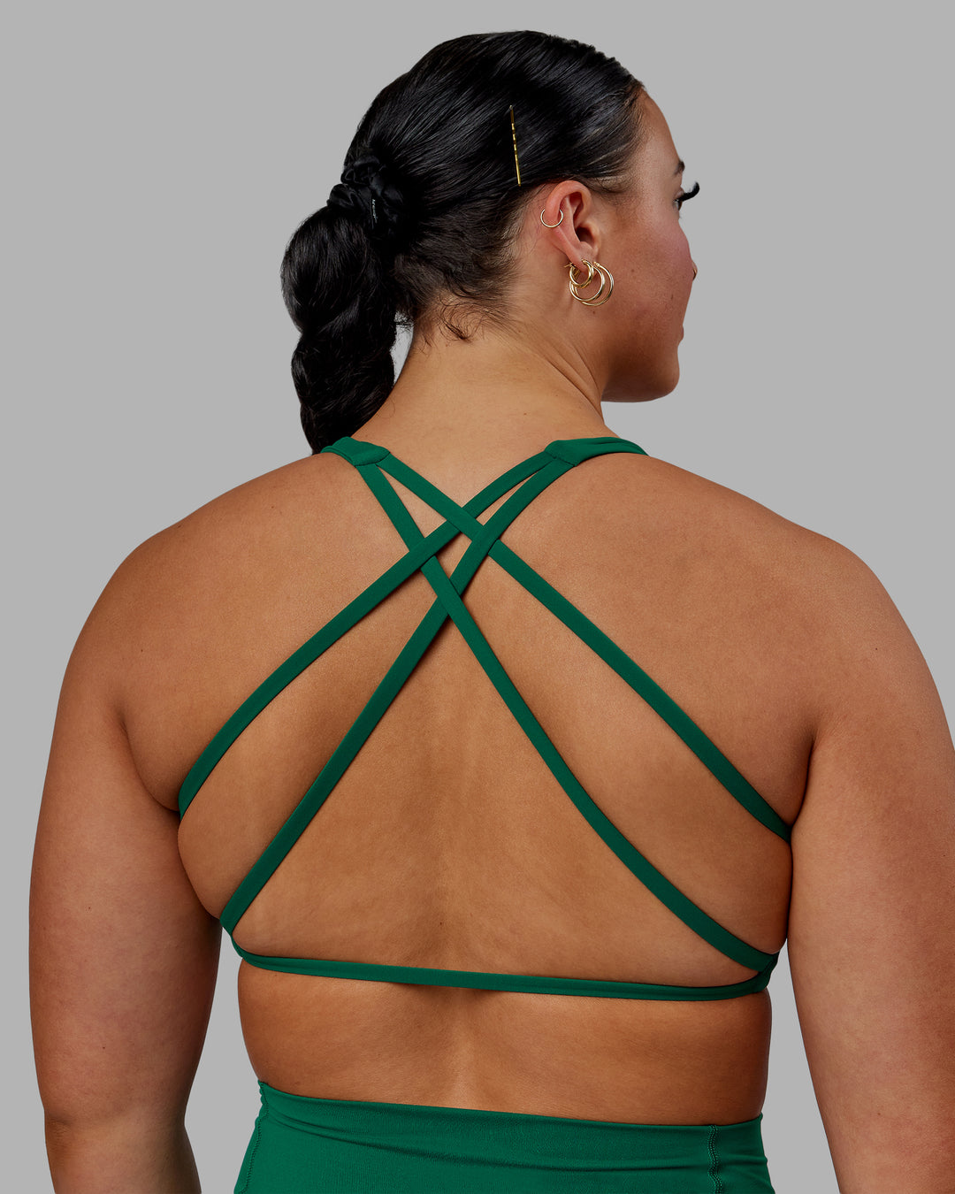 Woman wearing Aspire Sports Bra - Malachite