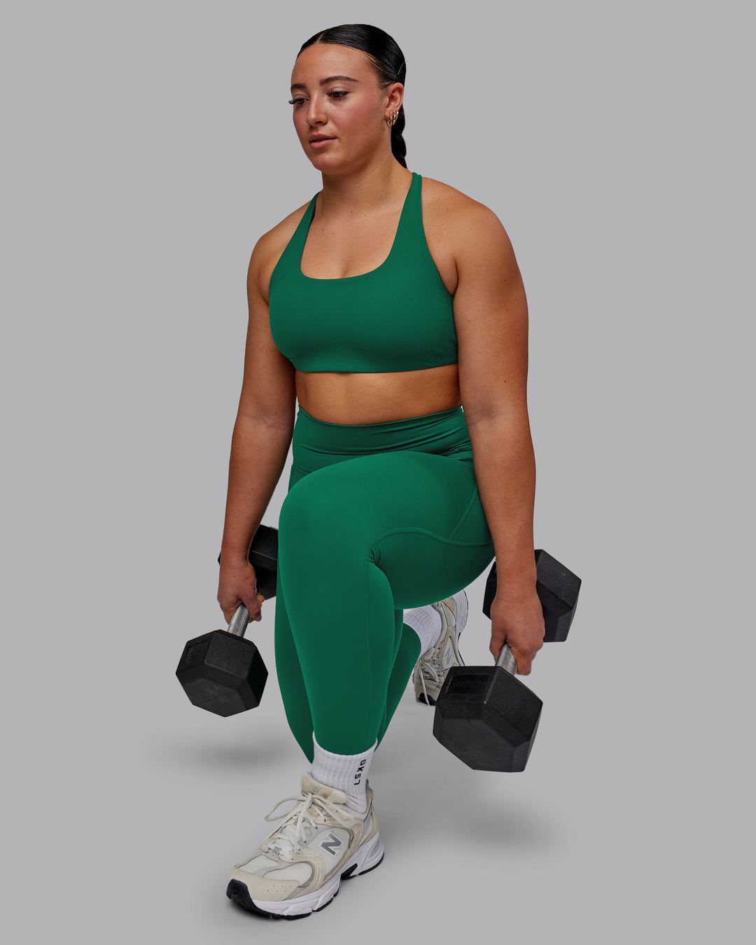 Woman wearing Aspire Sports Bra - Malachite