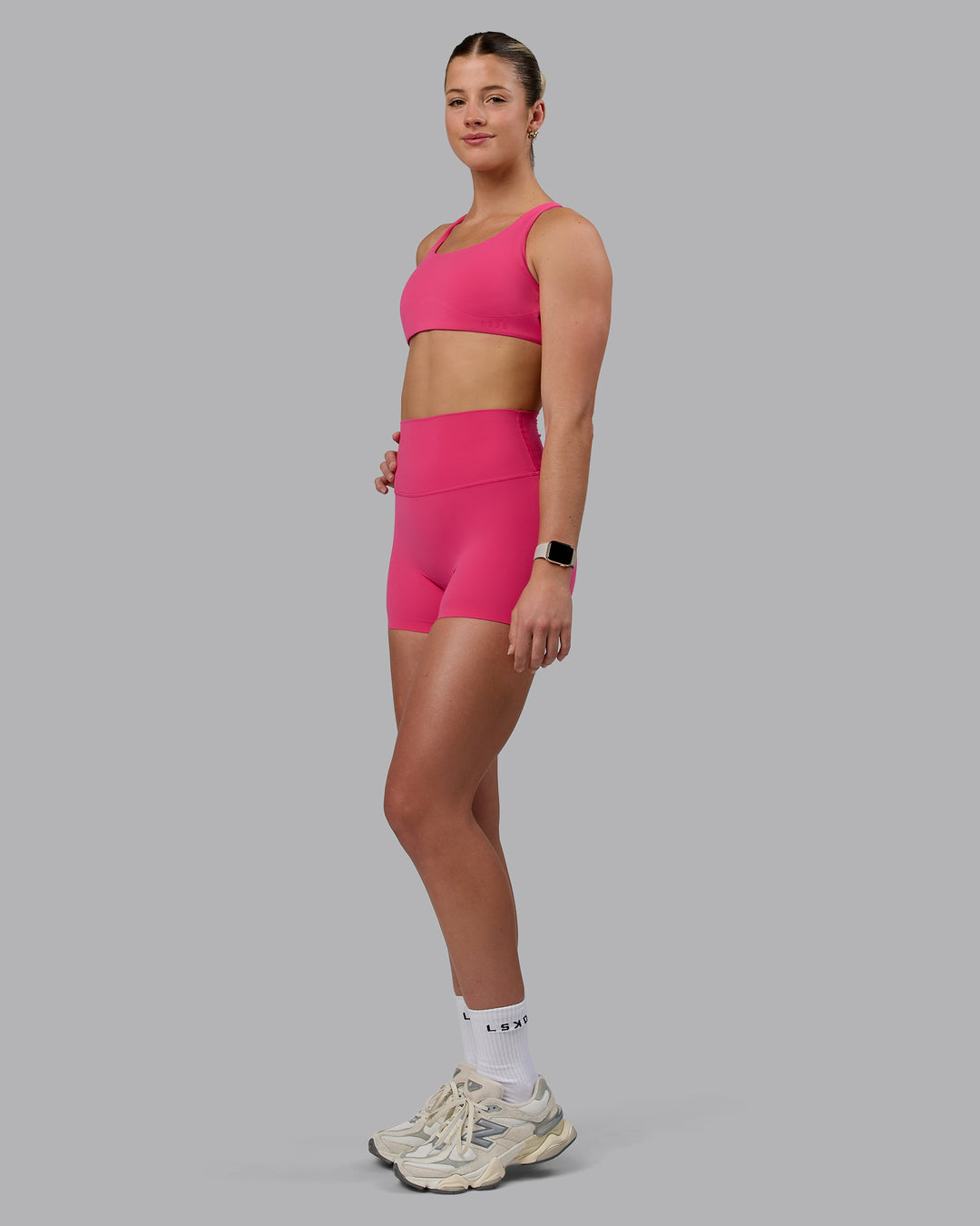 Woman wearing Aspire Sports Bra - Pink Flash