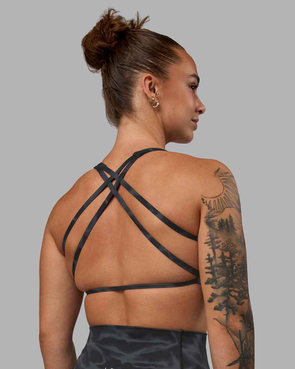 Woman wearing Aspire Sports Bra - Tranquil-Black