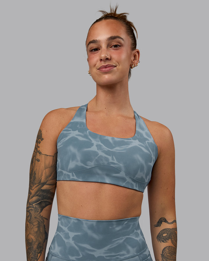 Woman wearing Aspire Sports Bra - Tranquil-Elemental Blue
