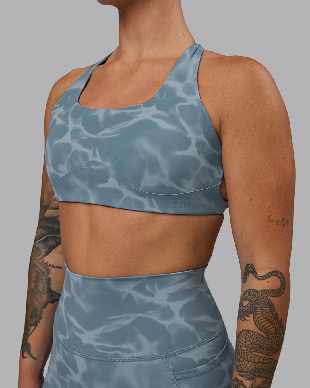 Woman wearing Aspire Sports Bra - Tranquil-Elemental Blue