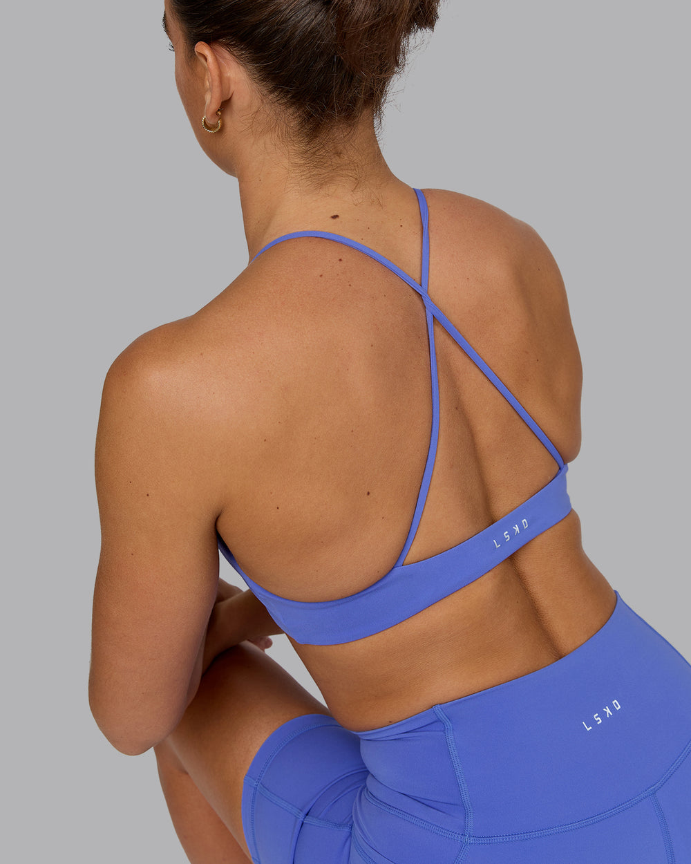 Woman wearing Aura Sports Bra - Baja Blue