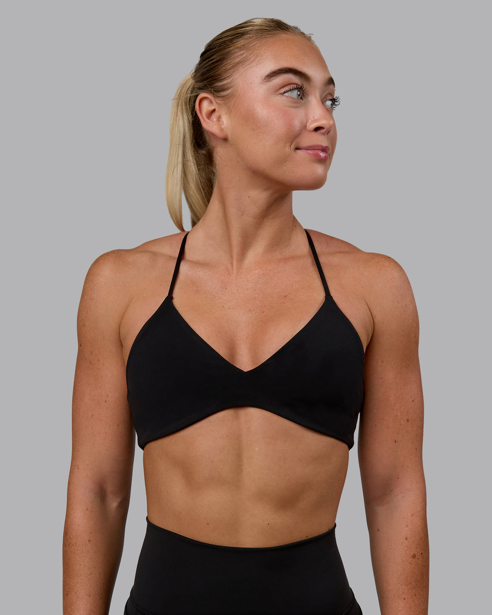 Woman wearing Aura Sports Bra - Black