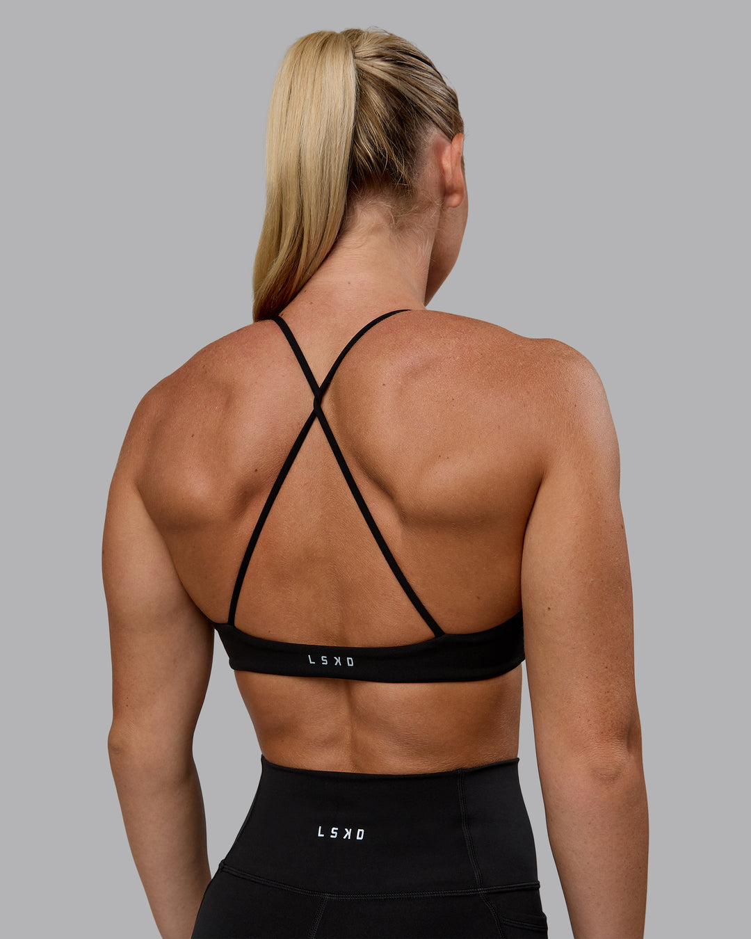 Woman wearing Aura Sports Bra - Black