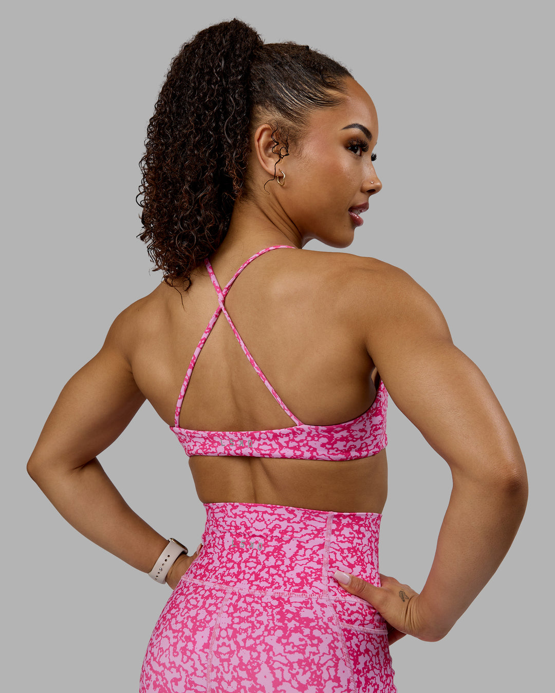 Woman wearing Aura Sports Bra - Patina-Ultra Pink