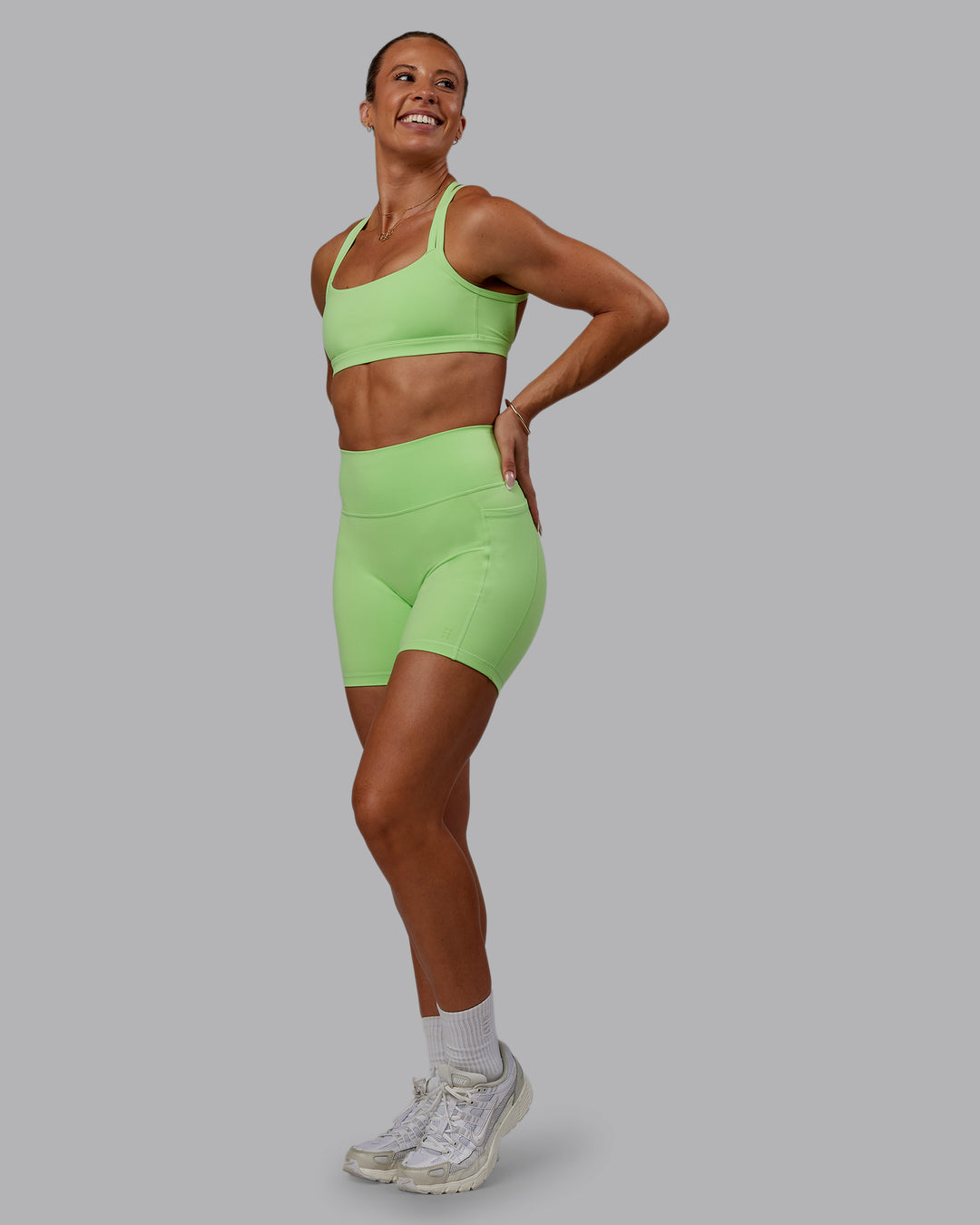 Woman wearing Bree Masters Fusion Mid Short Tights with Pockets - Pastel Lime