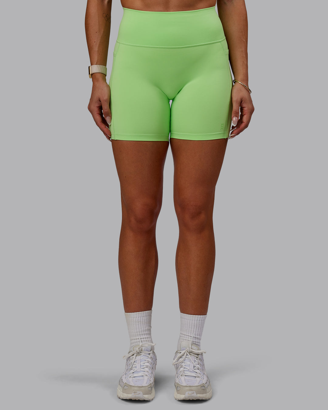 Woman wearing Bree Masters Fusion Mid Short Tights with Pockets - Pastel Lime