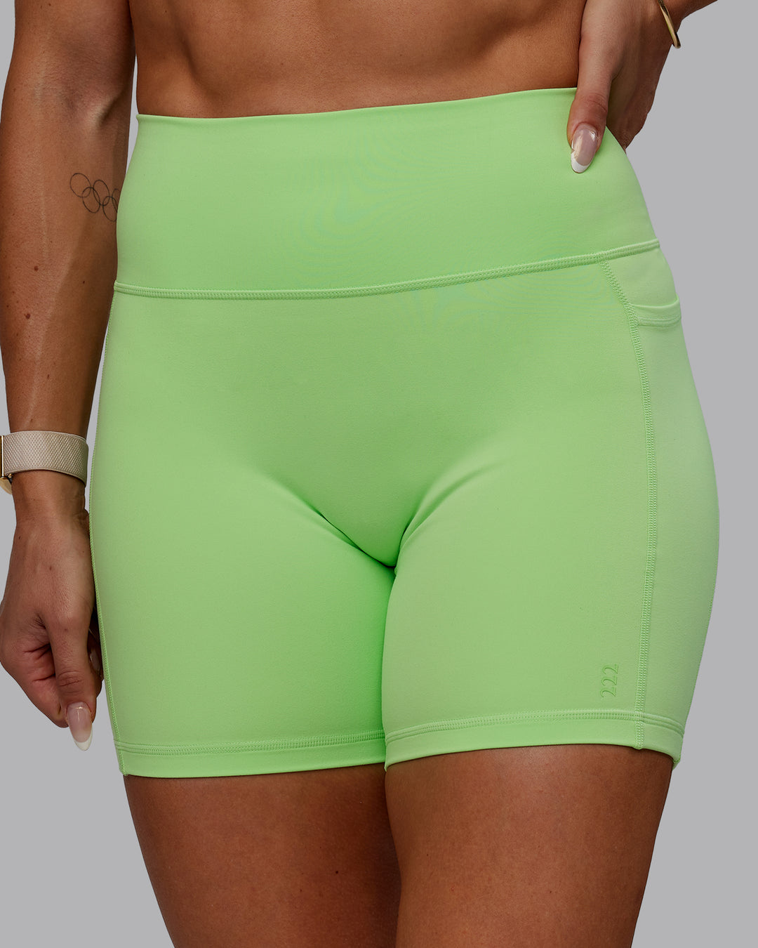 Woman wearing Bree Masters Fusion Mid Short Tights with Pockets - Pastel Lime